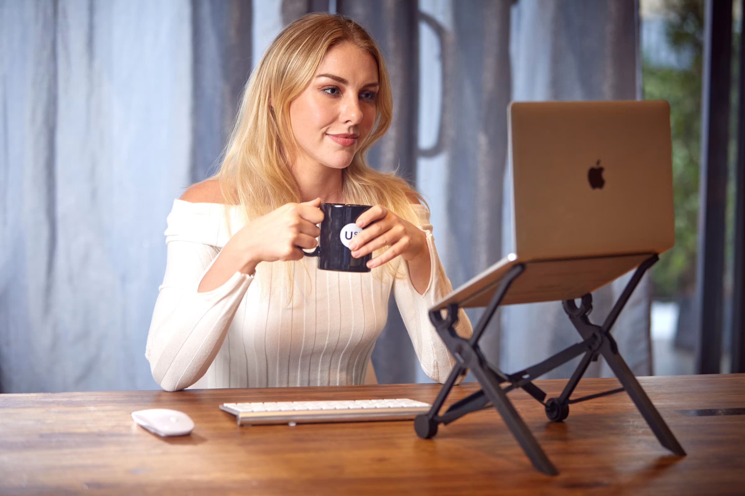 A professional working securely on a laptop in a bright workspace